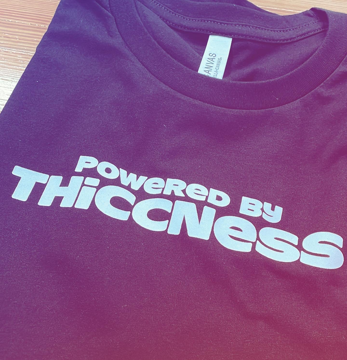 Powered by Thiccness unisex tee