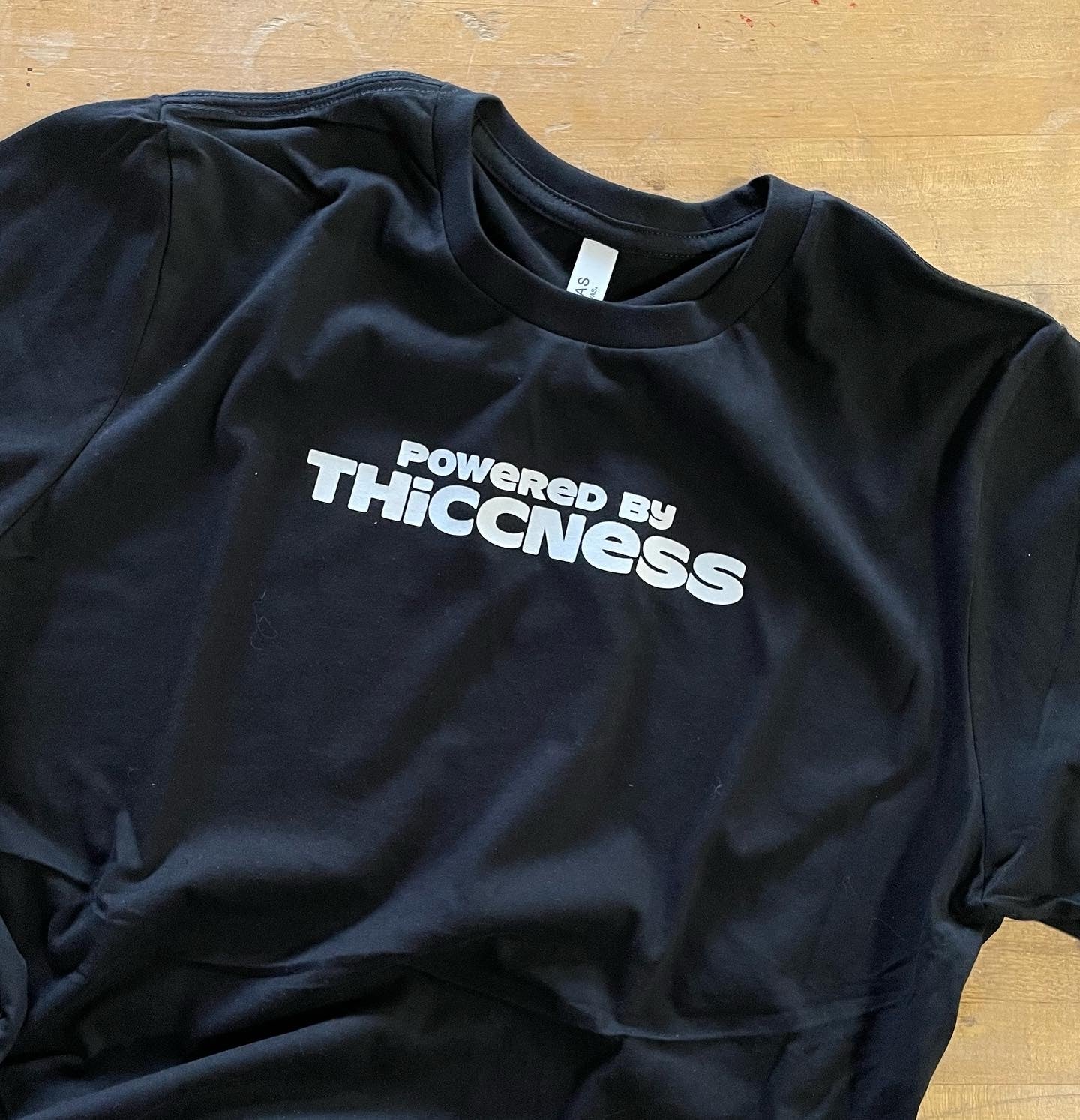 Powered by Thiccness unisex tee